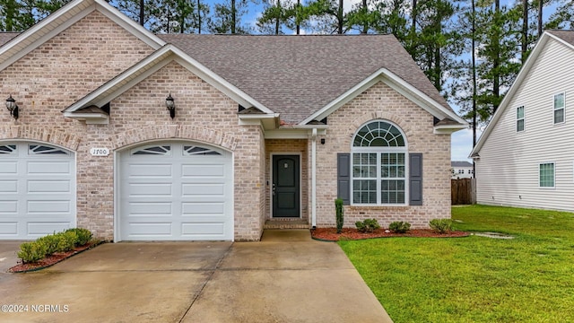 view of front of house featuring a garage and a front yard