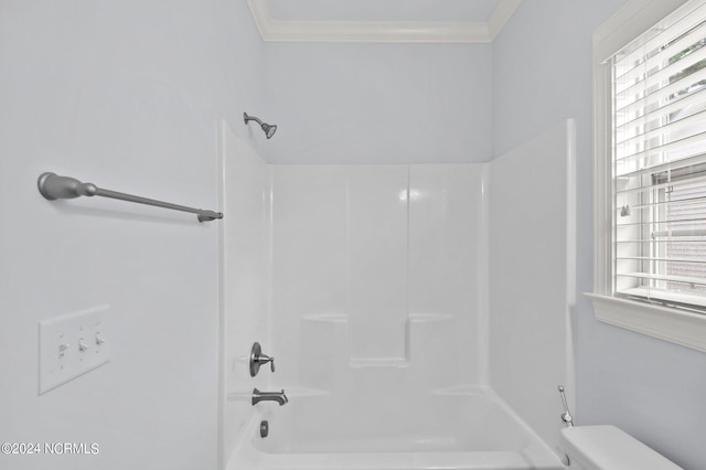 bathroom featuring tub / shower combination, crown molding, toilet, and a healthy amount of sunlight