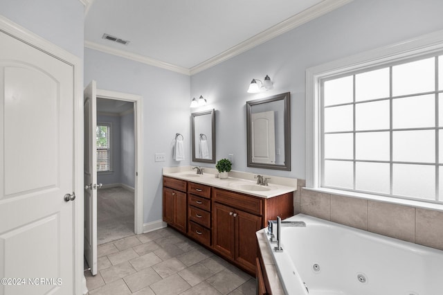 bathroom featuring vanity, tile patterned floors, ornamental molding, and a tub