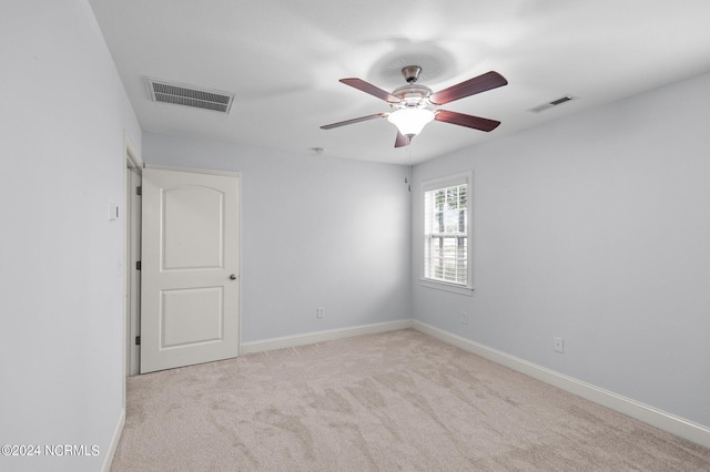 carpeted spare room with ceiling fan