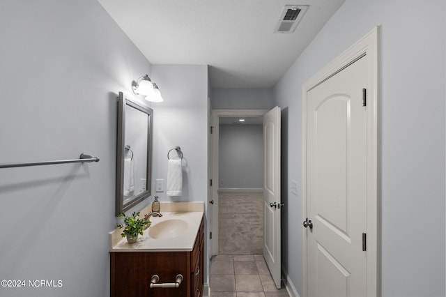 bathroom featuring tile patterned flooring and vanity