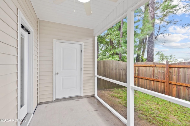 unfurnished sunroom with ceiling fan