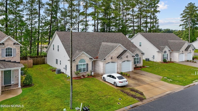 view of front of home featuring central AC unit, a front yard, and a garage