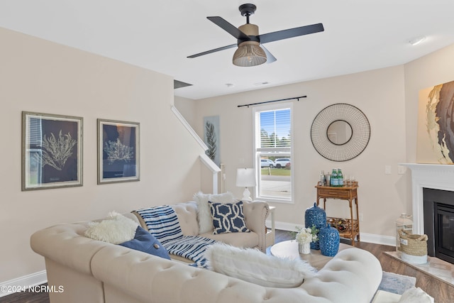 living room featuring hardwood / wood-style flooring and ceiling fan