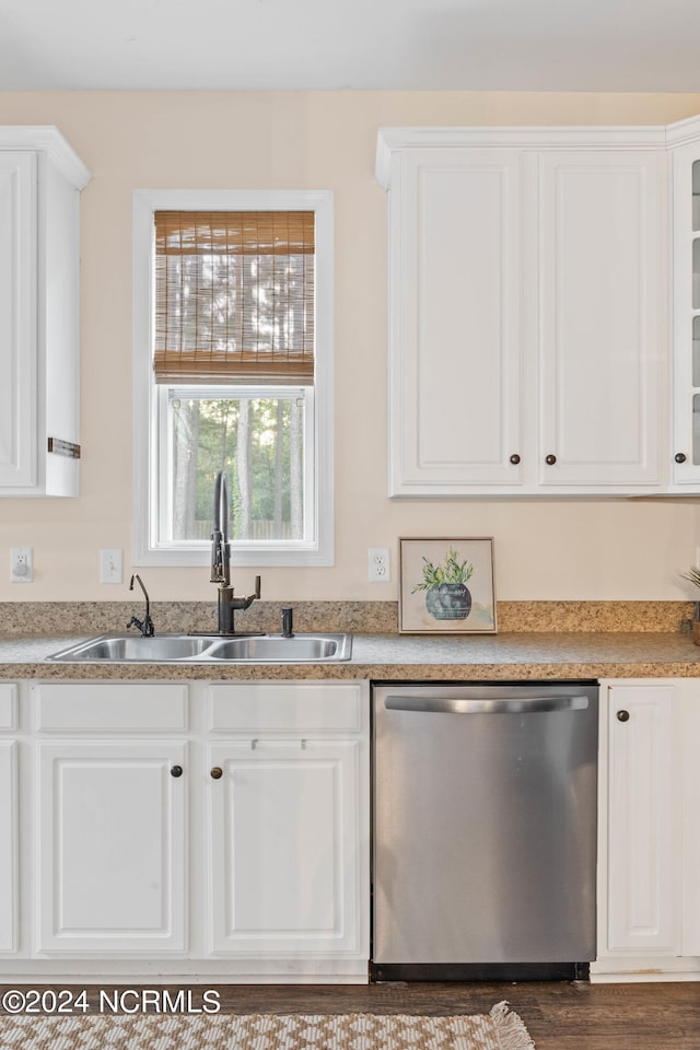 kitchen featuring dishwasher, white cabinetry, and sink