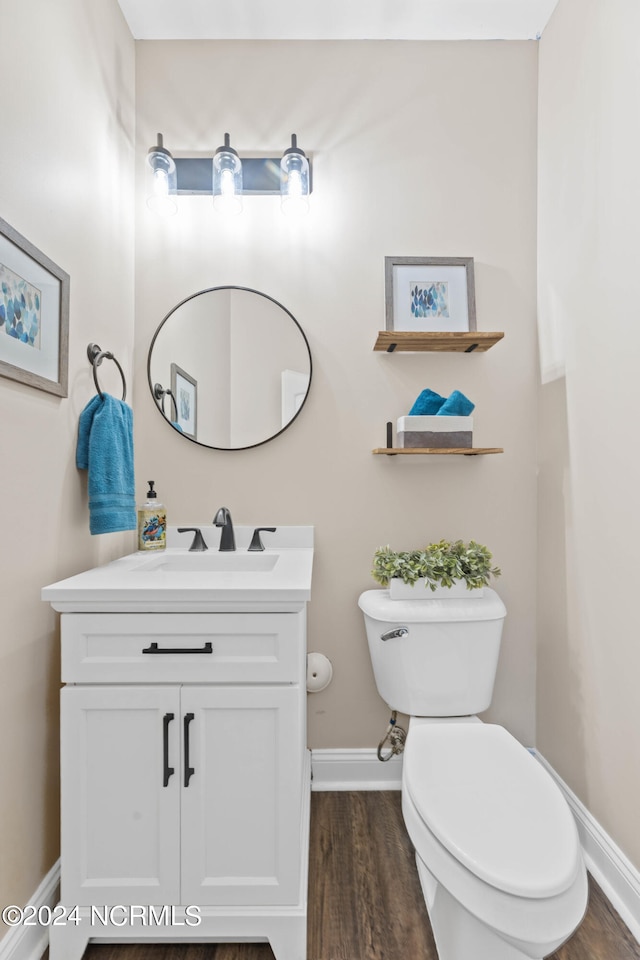 bathroom featuring hardwood / wood-style floors, vanity, and toilet