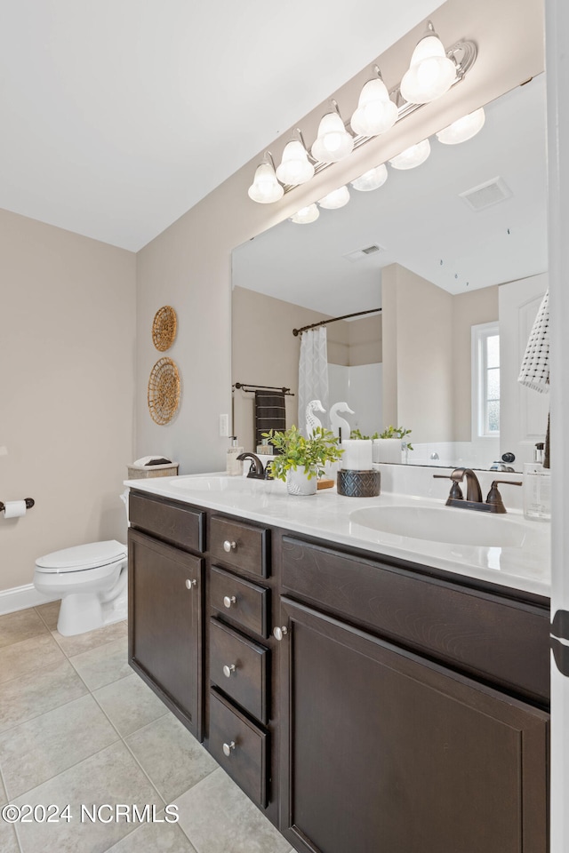 bathroom featuring walk in shower, tile patterned flooring, vanity, and toilet