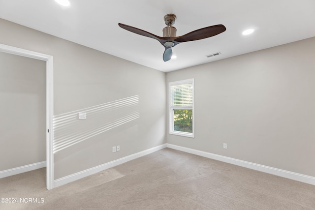 carpeted spare room with ceiling fan