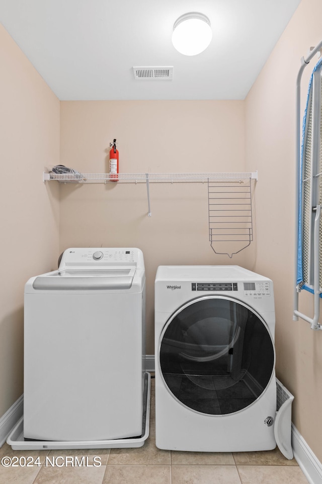 washroom featuring light tile patterned floors and separate washer and dryer