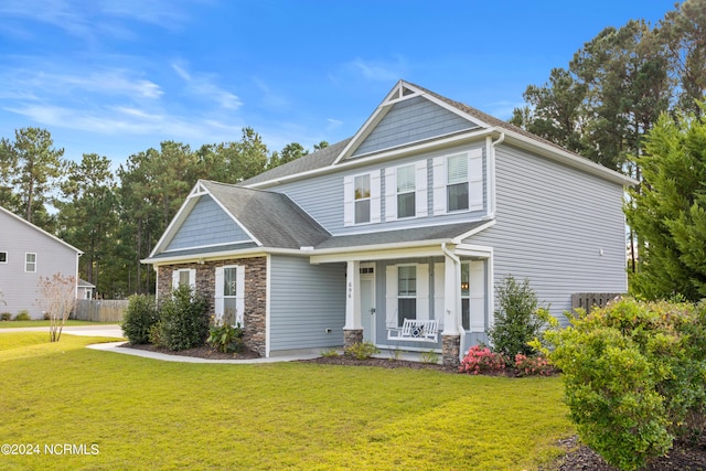 view of front facade with covered porch and a front yard