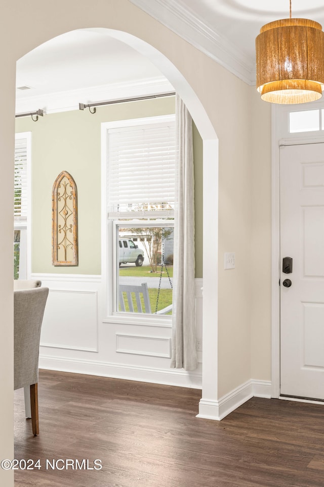 foyer featuring dark hardwood / wood-style floors and crown molding