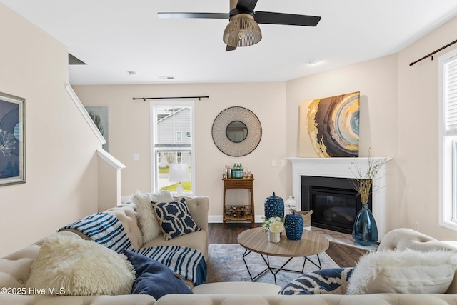 living room featuring ceiling fan and hardwood / wood-style flooring