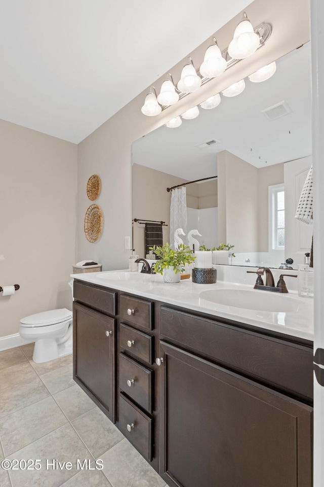 bathroom featuring a shower with curtain, vanity, toilet, and tile patterned floors