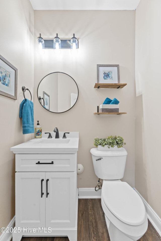 bathroom featuring hardwood / wood-style flooring, vanity, and toilet