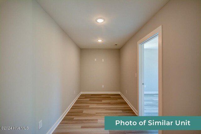 spare room with ceiling fan and light hardwood / wood-style flooring