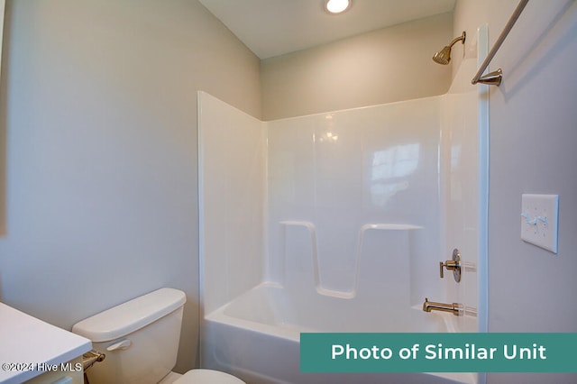 bathroom with toilet, washtub / shower combination, and vanity