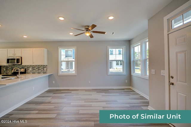 kitchen featuring recessed lighting, stainless steel appliances, ceiling fan, light countertops, and white cabinets