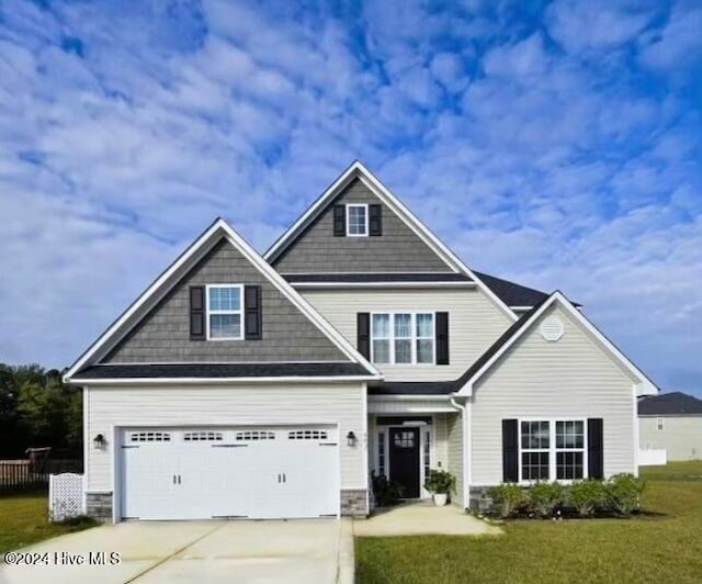 craftsman-style house featuring a front yard and a garage