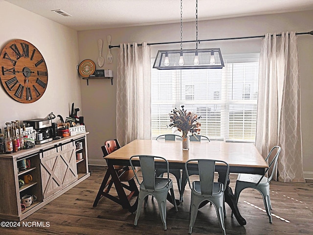 dining area featuring dark wood-type flooring