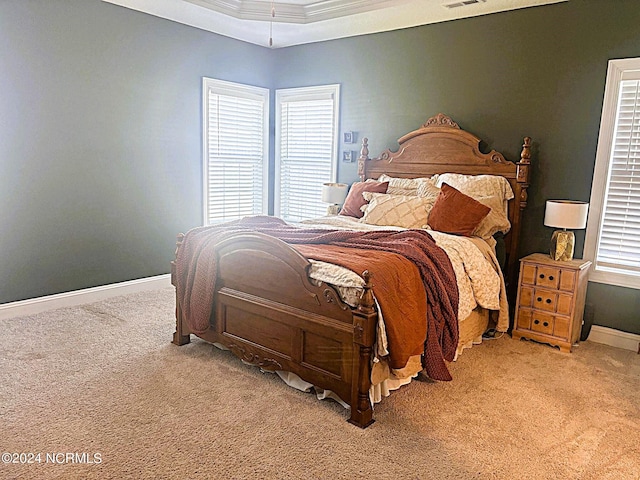 carpeted bedroom featuring multiple windows and crown molding