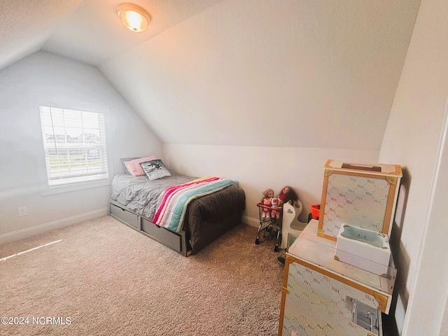 bedroom featuring a textured ceiling, vaulted ceiling, and carpet