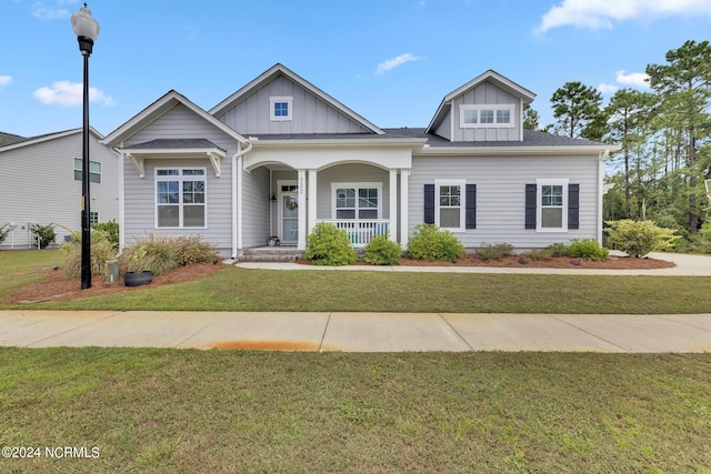 view of front of property with a porch and a front lawn