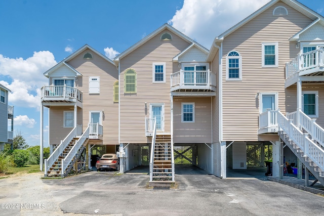 view of front facade featuring a carport and a balcony