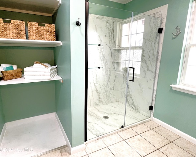 bathroom with walk in shower and tile patterned flooring