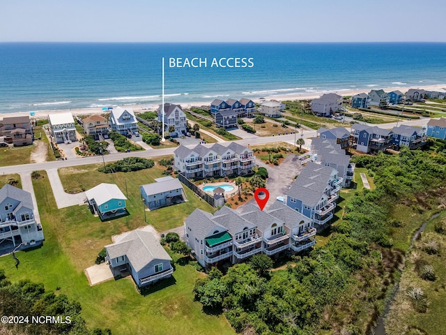 bird's eye view with a water view and a beach view