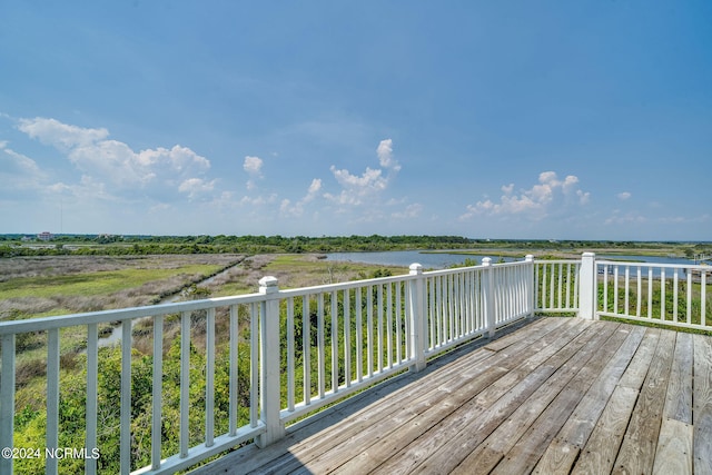 wooden terrace featuring a water view