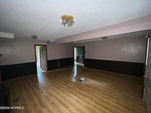 interior space featuring a textured ceiling and hardwood / wood-style floors