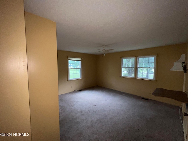 carpeted empty room featuring ceiling fan