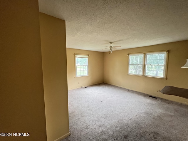 205 E Pinewood St, Roseboro, NC 28382 - unfurnished room with a textured ceiling, ceiling fan, and carpet