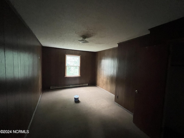 205 E Pinewood St, Roseboro, NC 28382 - spare room featuring wood walls and a baseboard radiator