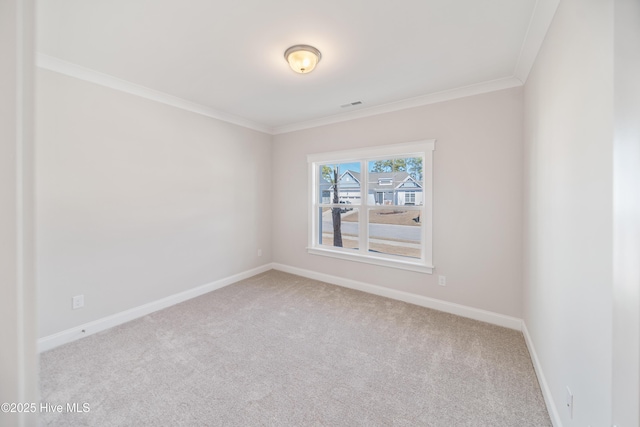 unfurnished room featuring light carpet, ornamental molding, and baseboards