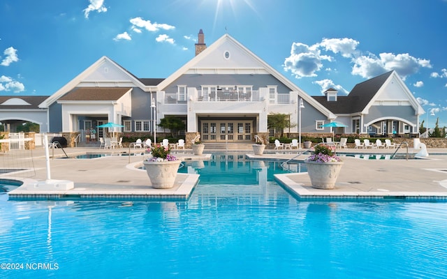 pool featuring french doors and a patio area