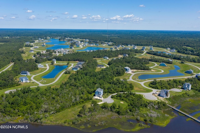 drone / aerial view with a water view and a view of trees