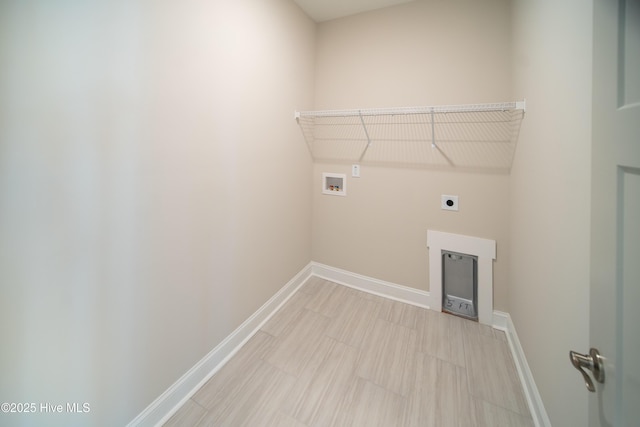 clothes washing area with baseboards, laundry area, washer hookup, and hookup for an electric dryer