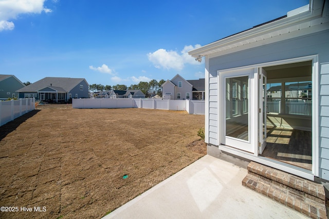 view of yard featuring a fenced backyard and a residential view