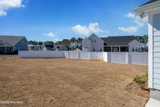 view of yard featuring a residential view and fence