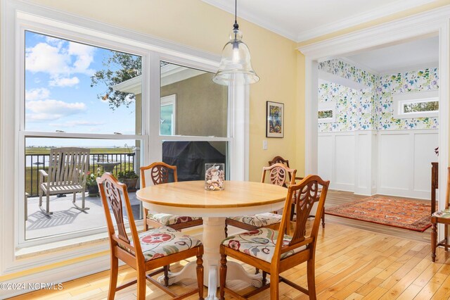 1324 Harbour Watch SW, Calabash, NC 28467 - dining room with light wood-style floors, a decorative wall, wainscoting, and crown molding