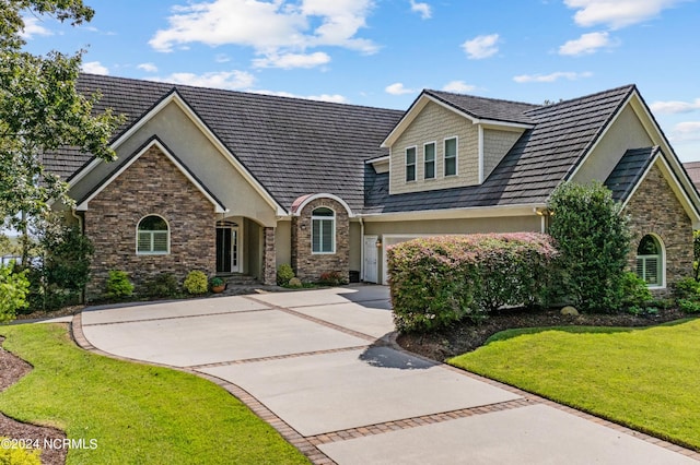 view of front of house featuring a garage and a front lawn