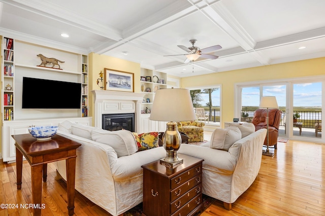 living room featuring light wood-type flooring, ceiling fan, and coffered ceiling