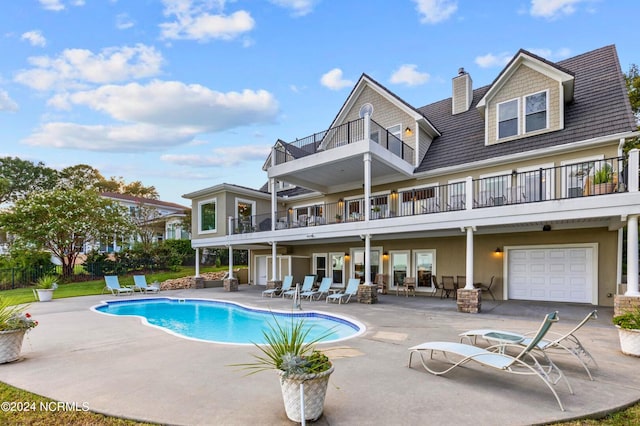 1324 Harbour Watch SW, Calabash, NC 28467 - rear view of property featuring a balcony, a patio, an outdoor pool, and a chimney