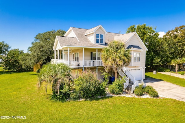 view of front facade featuring a garage, covered porch, and a front lawn