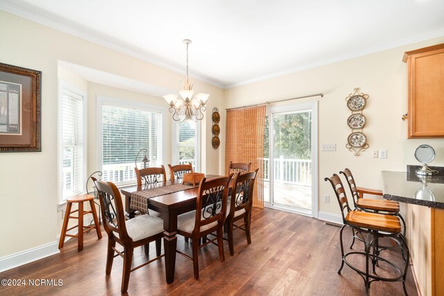 dining area featuring a notable chandelier, ornamental molding, and dark hardwood / wood-style flooring