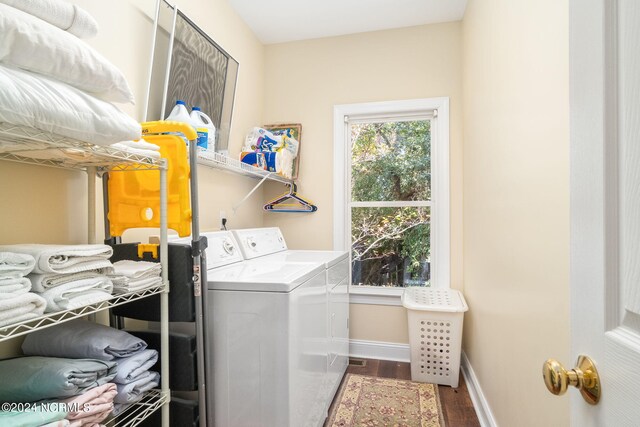 laundry area with washer and clothes dryer and dark hardwood / wood-style flooring