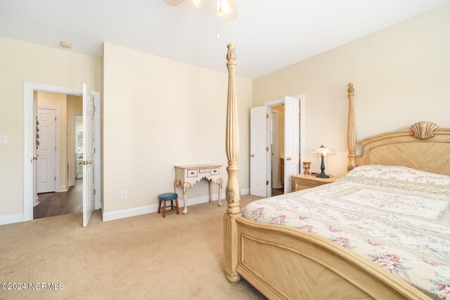 bedroom with ceiling fan and light colored carpet