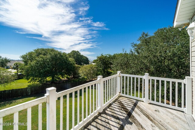 wooden deck with a lawn