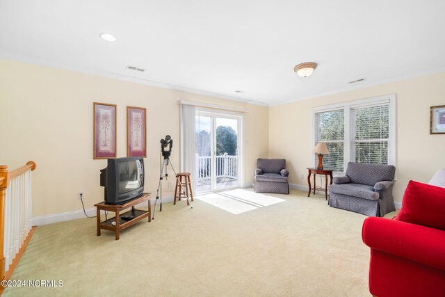 carpeted living room with crown molding